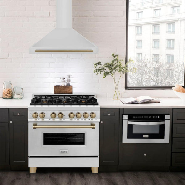 ZLINE Autograph Edition Convertible Stainless Steel Range Hood with Stainless Steel Shell and Champagne Bronze Accents (KB4STZ-CB) in a luxury compact kitchen with matching range and microwave, front.