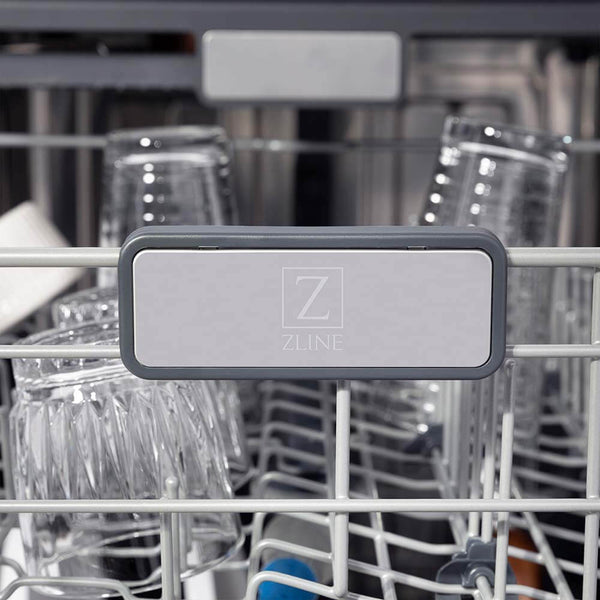 ZLINE 24 in. Monument Series 3rd Rack Top Touch Control Dishwasher with Fingerprint Resistant Stainless Steel Panel, 45dBa (DWMT-SN-24) close-up, ZLINE logo on dish rack.