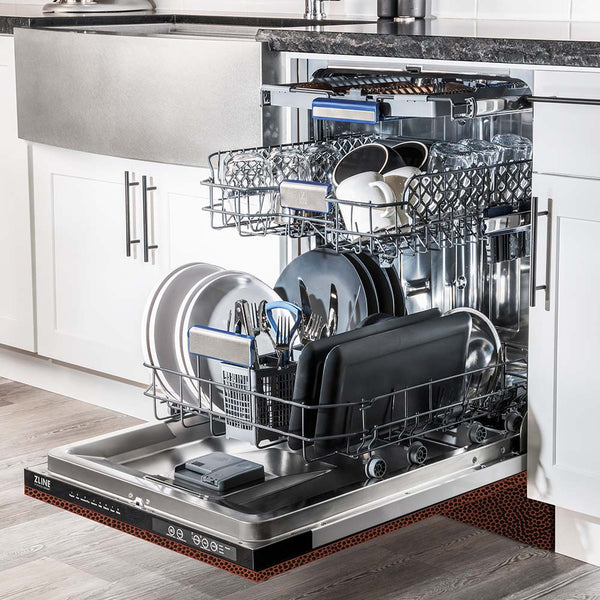 ZLINE 24" Tallac Series 3rd Rack Dishwasher with Hand-Hammered Copper Panel and Traditional Handle, 51dBa (DWV-HH-24) in a luxury kitchen from side, open with dishes loaded on all dish racks.