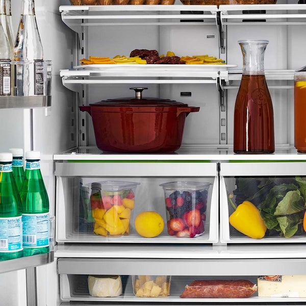 Close-up of food and beverages on adjustable shelving from front inside ZLINE Autograph Edition 36 in. 22.5 cu. ft Freestanding French Door Refrigerator with Ice Maker in Fingerprint Resistant Stainless Steel with Champagne Bronze Accents (RFMZ-36-CB)