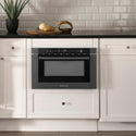 ZLINE 24 in. 1.2 cu. ft. Black Stainless Steel Built-in Microwave Drawer with a Traditional Handle (MWD-1-BS-H) in Rustic Farmhouse Style Kitchen with white cabinets and black countertops.