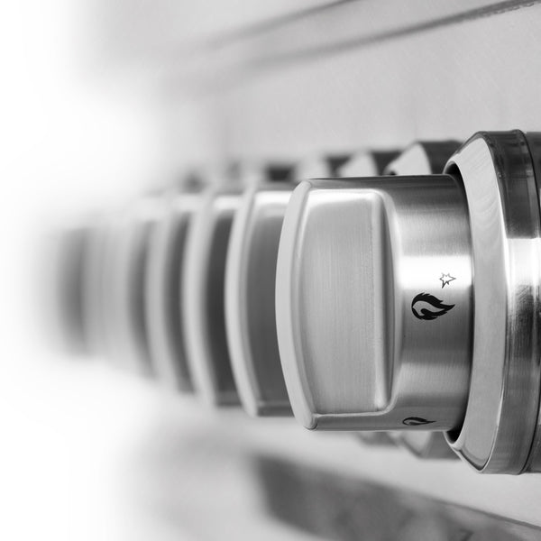 Stainless steel cooktop and oven control knobs.