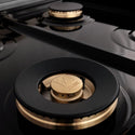 ZLINE brass burners and black porcelain cooktop close up.