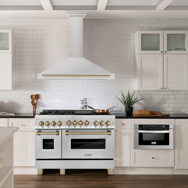 ZLINE Autograph Edition Convertible Stainless Steel Range Hood with Stainless Steel Shell and Champagne Bronze Accents (KB4STZ-CB) in a luxury kitchen with matching range and microwave.