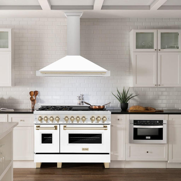 ZLINE Autograph Edition Convertible Stainless Steel Range Hood with White Matte Shell and Polished Gold Accents (KB4STZ-WM-G) in a luxury kitchen with matching range and microwave.