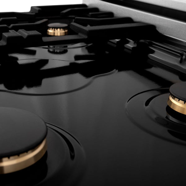 ZLINE brass burners on black porcelain cooktop with no grates.