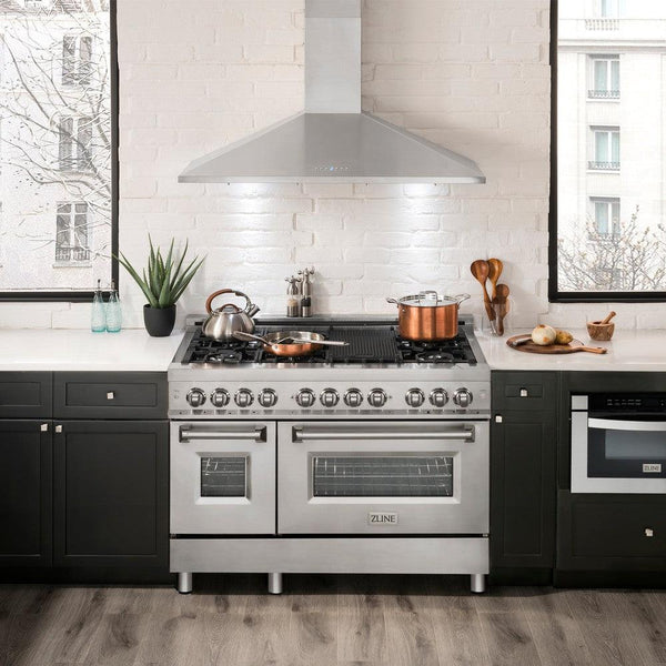ZLINE Convertible Vent Wall Mount Range Hood in Stainless Steel (KL2) above a double oven range in a luxury apartment kitchen.