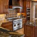 ZLINE 48" range in rustic kitchen with wood cabinets
